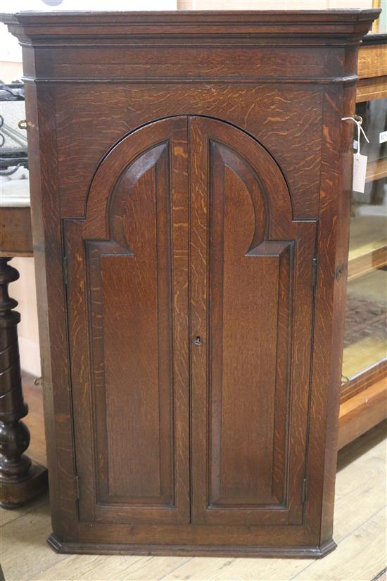 A George III oak corner cupboard W.66cm